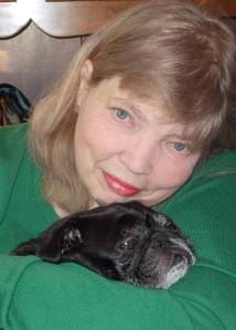 Author Jean Rabe snuggles with her black pug, Mr. Wrinkles